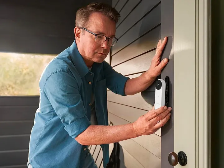 A man installing the Google Nest Doorbell