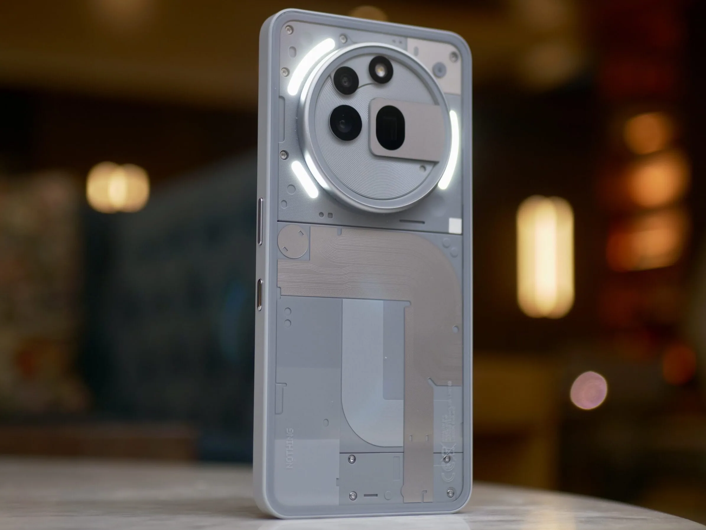 The back of the Nothing Phone 3a Pro, with the Glyph Lights active.