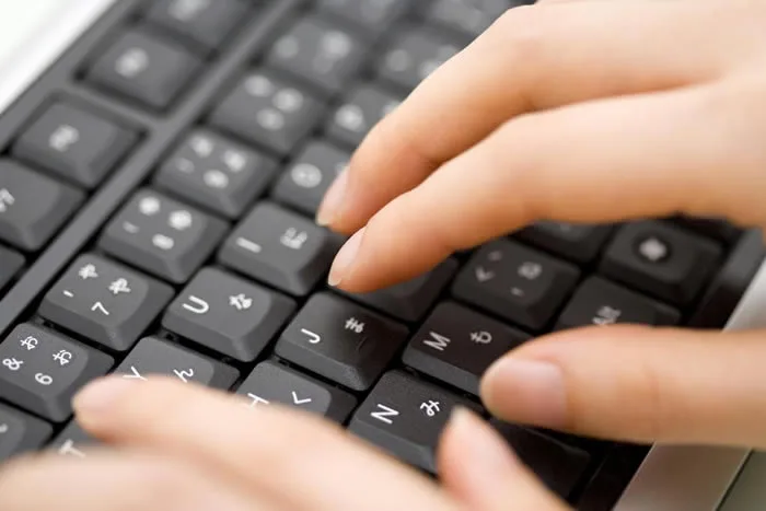 A person typing on a keyboard.