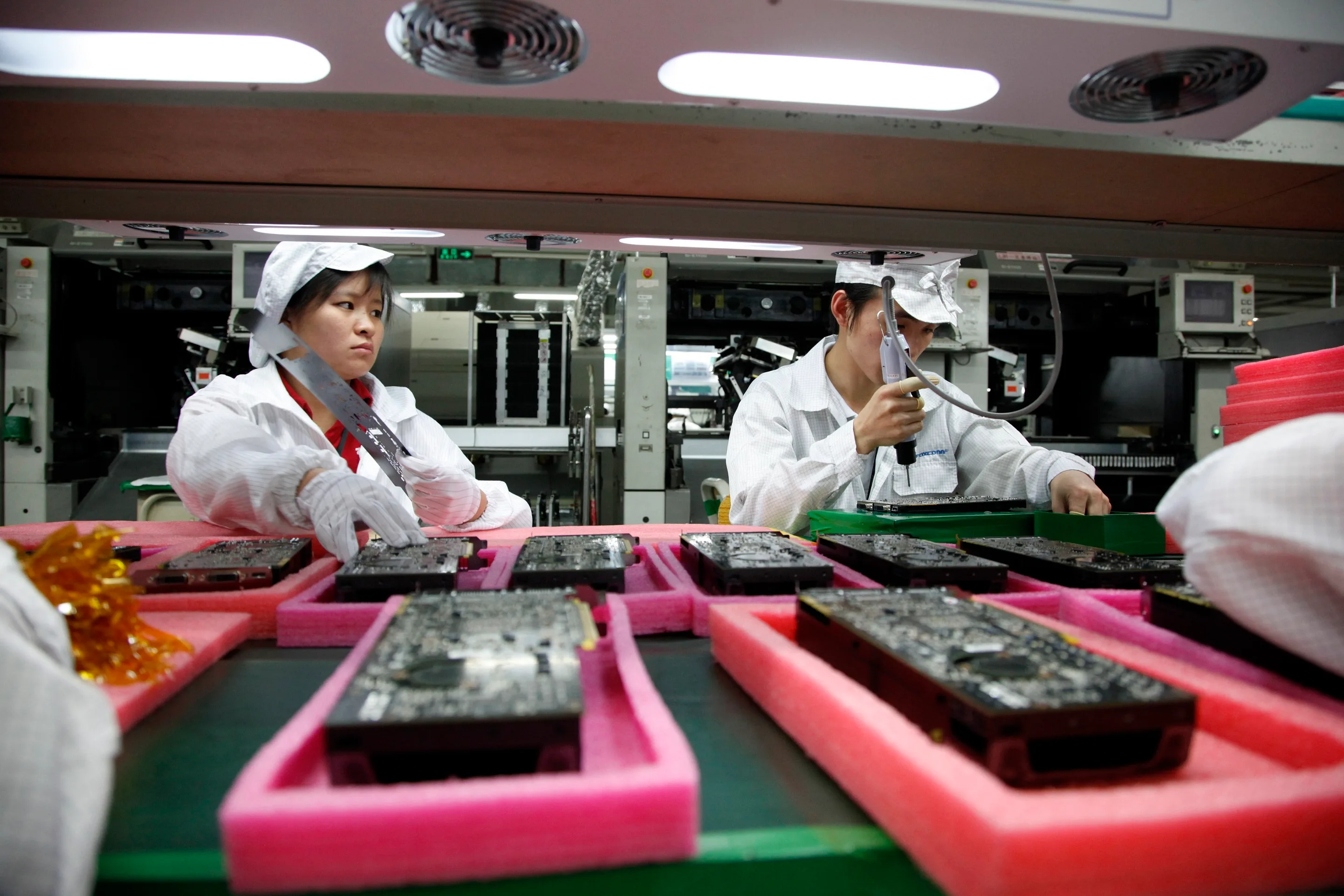 Employees work on the assembly line at a Foxconn plant in Shenzhen, China.