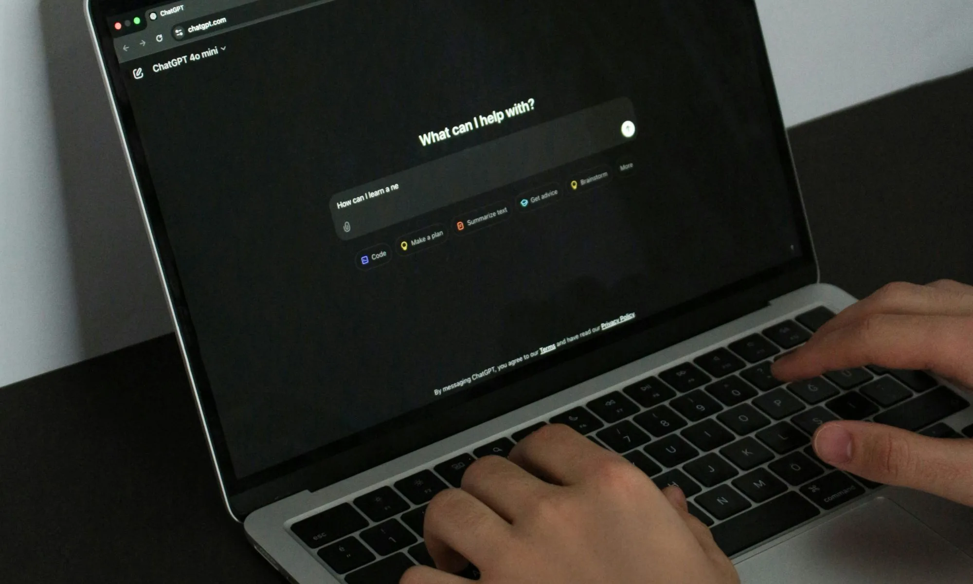 Person using ChatGPT on a MacBook